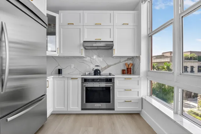 a kitchen with stainless steel appliances a stove a sink and a refrigerator