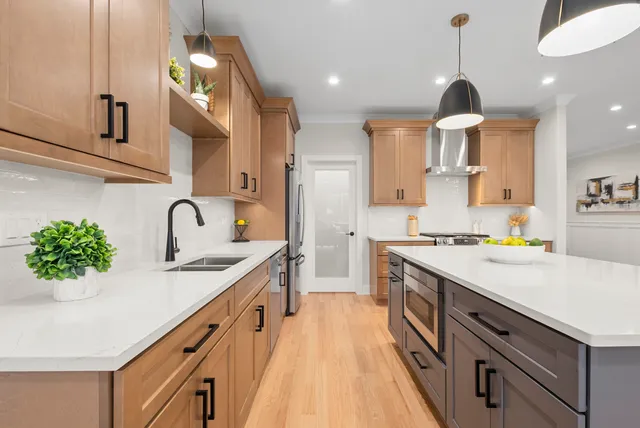a kitchen with kitchen island a sink appliances cabinets and a counter top space