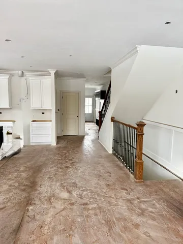 a view of a hallway with stairs and a window