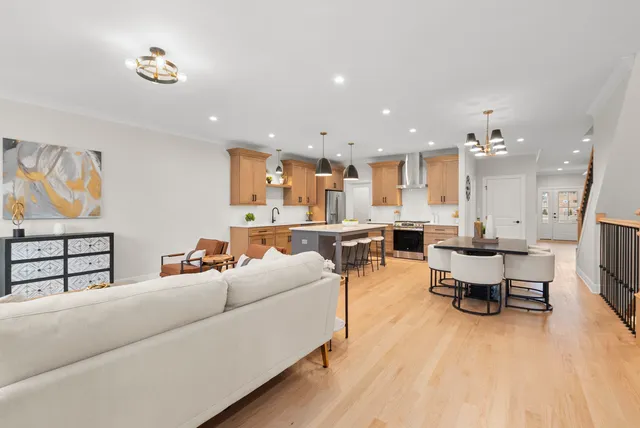 a living room with furniture kitchen view and a table