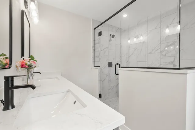 a bathroom with a tub sink and mirror