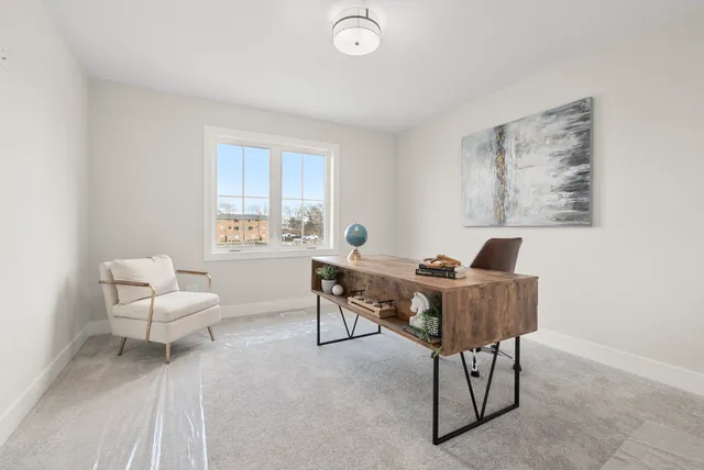 a work room with furniture and a window