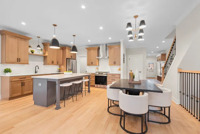 a large kitchen with a table and chairs