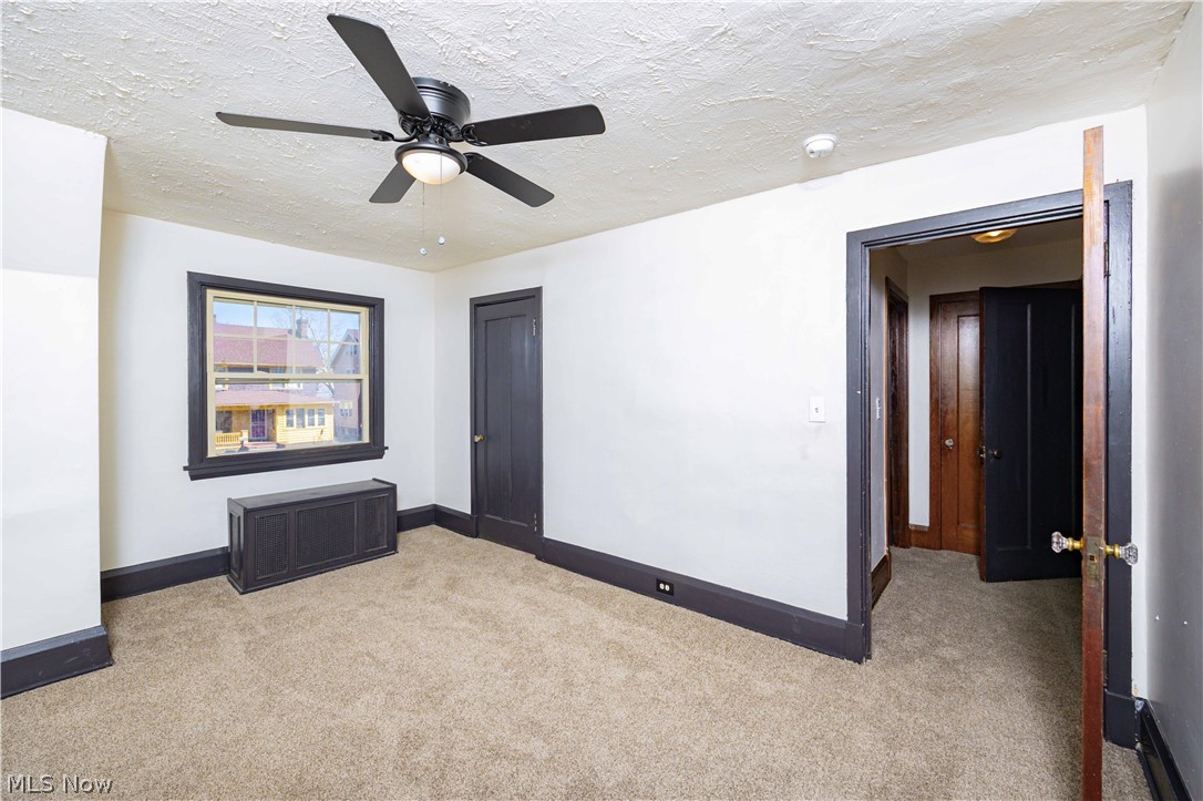3254 Redwood Road Cleveland Heights, OH 44118 - Photo 34 of 49 Unfurnished room with a textured ceiling, light colored carpet, and ceiling fan