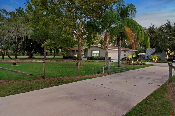 a front view of house with yard and green space