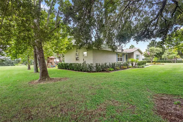 a front view of house with yard and green space