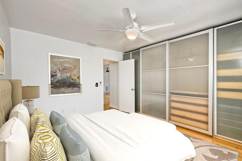 4549 Quailridge Drive Oceanside, CA 92056 - Photo 15 of 25 a bedroom with a bed and a chandelier