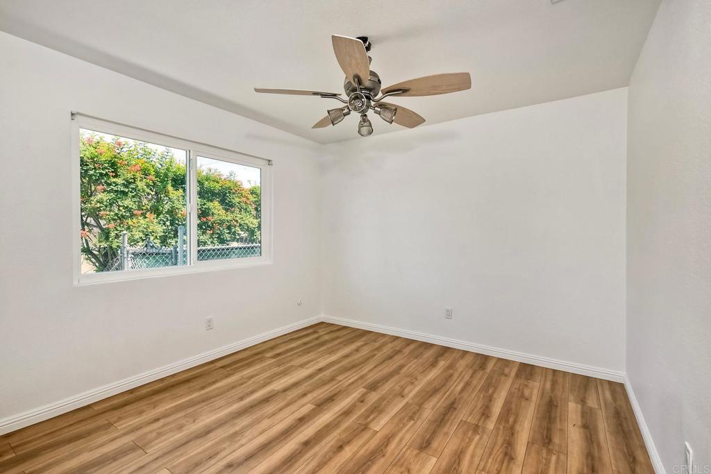 4549 Quailridge Drive Oceanside, CA 92056 - Photo 18 of 25 an empty room with a window and a fan