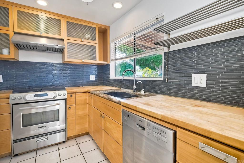 4549 Quailridge Drive Oceanside, CA 92056 - Photo 9 of 25 a kitchen with a sink stove and cabinets