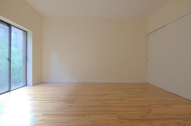 a view of an empty room and wooden floor