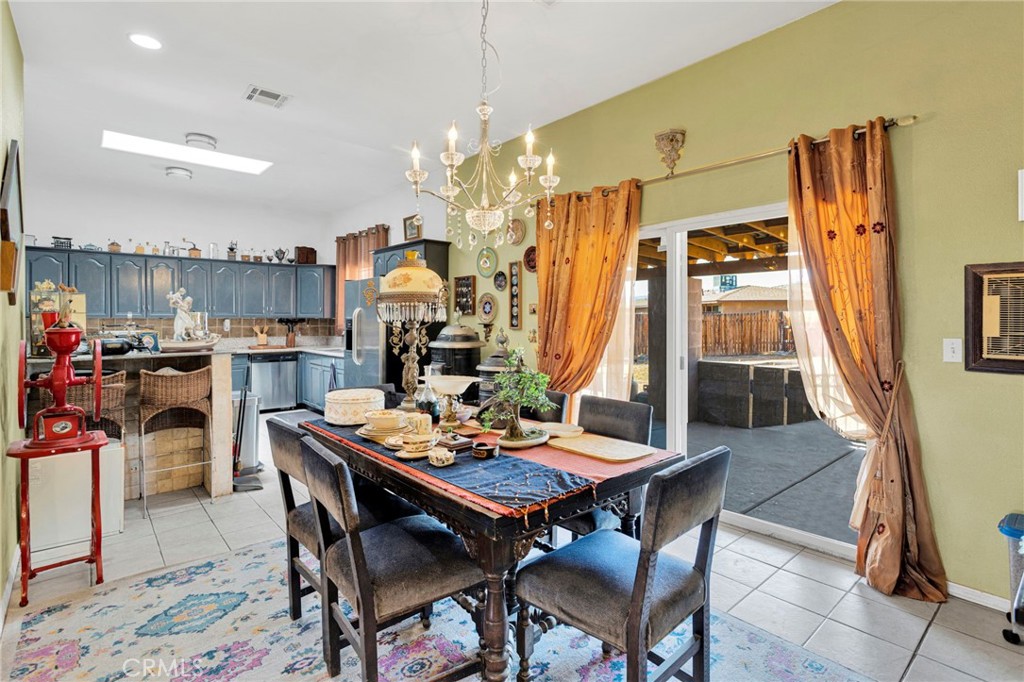 20151 Serrano Road Apple Valley, CA 92307 - Photo 15 of 59 a view of a dining room with furniture window and wooden floor