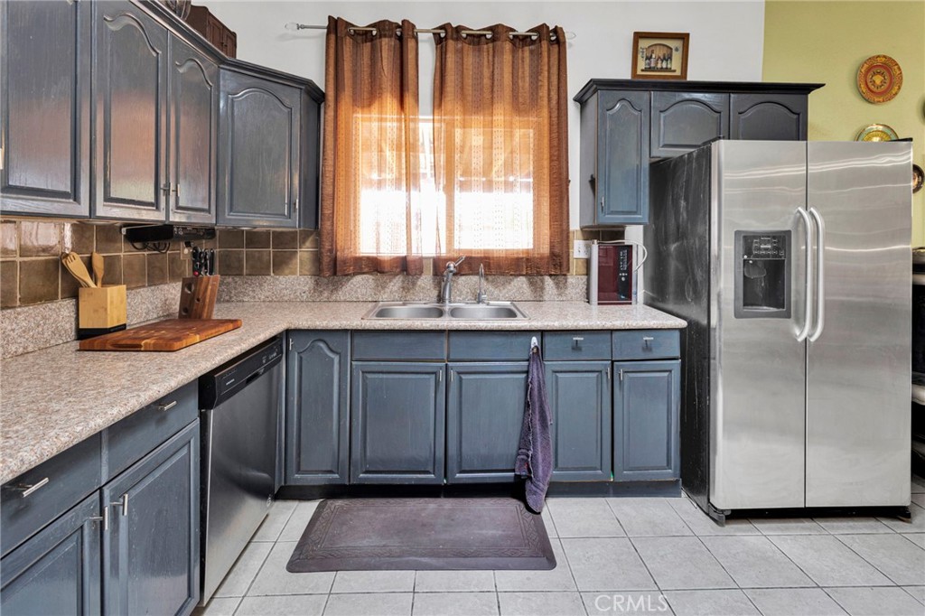 20151 Serrano Road Apple Valley, CA 92307 - Photo 20 of 59 a kitchen with stainless steel appliances granite countertop a refrigerator and a sink