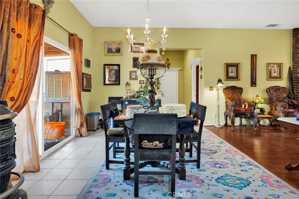 20151 Serrano Road Apple Valley, CA 92307 - Photo 21 of 59 a view of a dining room with furniture and wooden floor