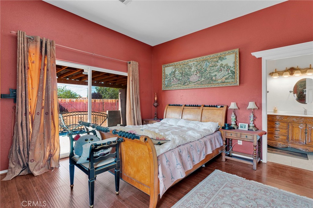20151 Serrano Road Apple Valley, CA 92307 - Photo 24 of 59 a bedroom with a bed and a dresser next to a window