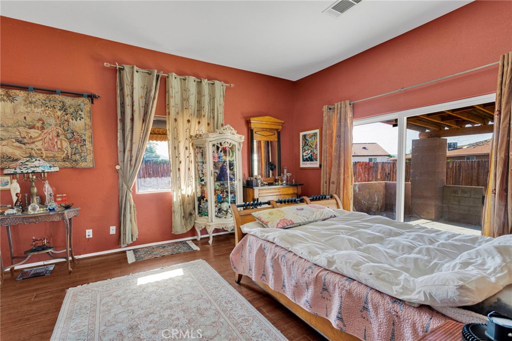 20151 Serrano Road Apple Valley, CA 92307 - Photo 30 of 59 a bed room with a bed and a large window