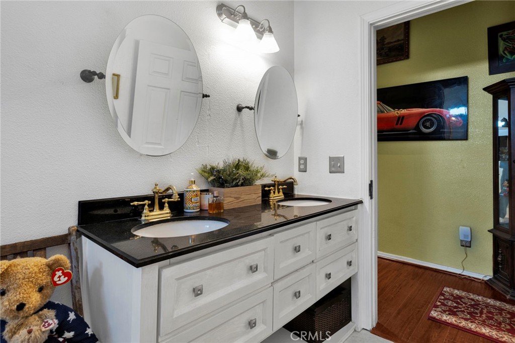 20151 Serrano Road Apple Valley, CA 92307 - Photo 31 of 59 a bathroom with a granite countertop double vanity sink and two mirror