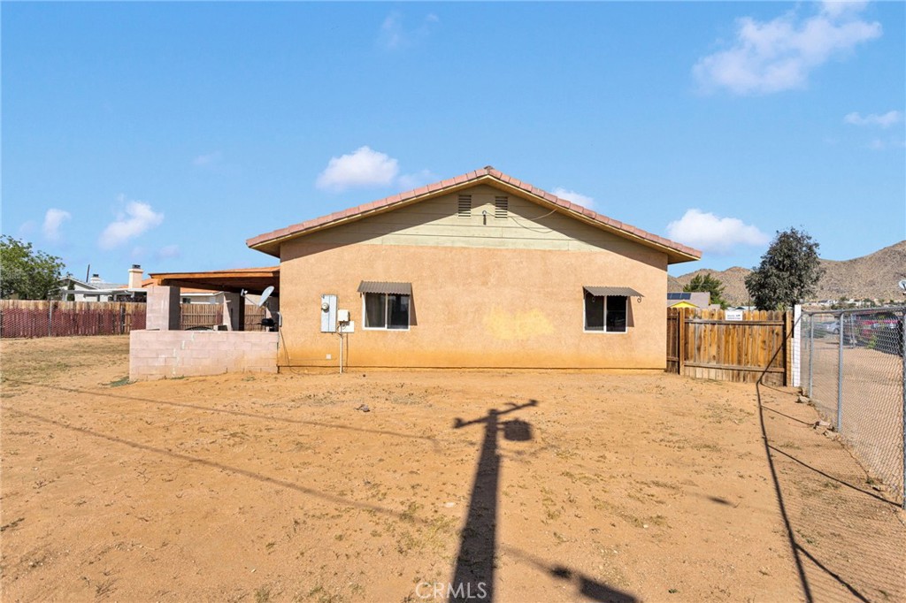 20151 Serrano Road Apple Valley, CA 92307 - Photo 44 of 59 a front view of a house with a yard