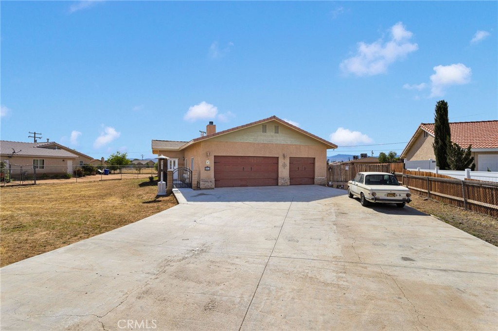 20151 Serrano Road Apple Valley, CA 92307 - Photo 5 of 59 a car parked in front of a house