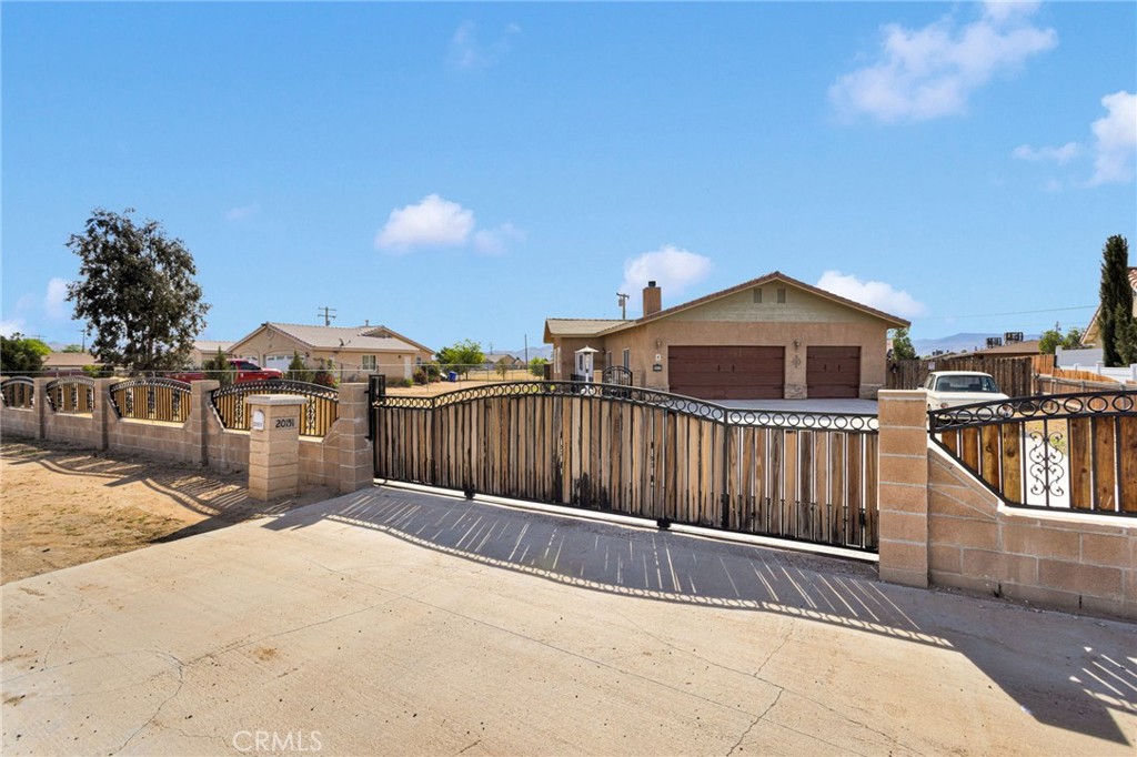 20151 Serrano Road Apple Valley, CA 92307 - Photo 6 of 59 a view of a house with wooden fence