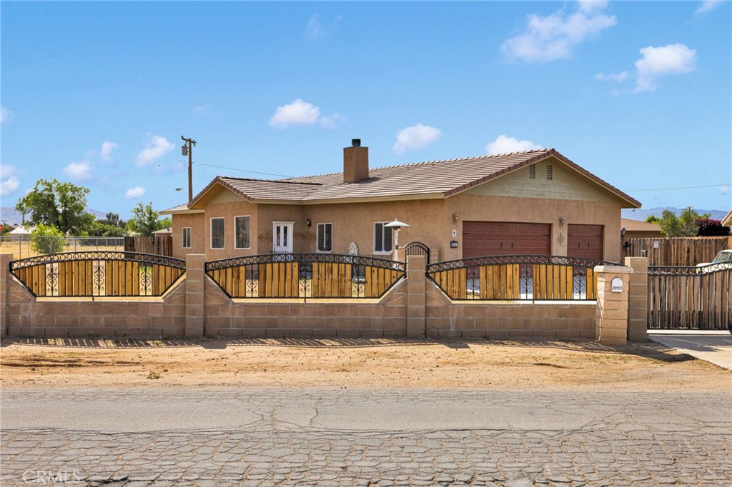 20151 Serrano Road Apple Valley, CA 92307 - Photo 7 of 59 a front view of a house with a yard