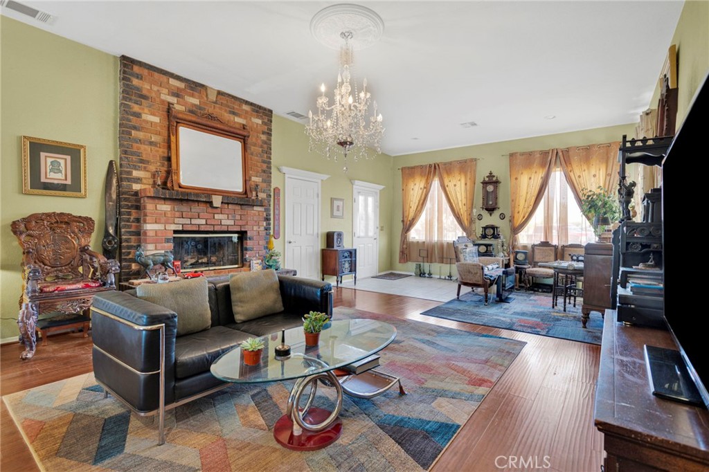 20151 Serrano Road Apple Valley, CA 92307 - Photo 8 of 59 a living room with furniture fireplace and a large window