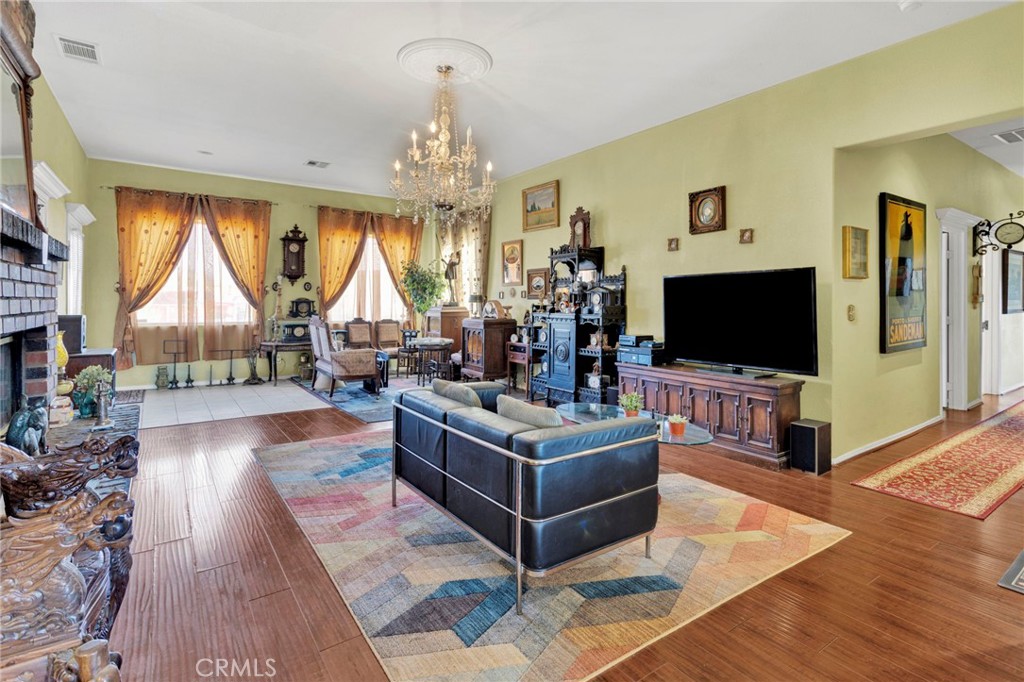 20151 Serrano Road Apple Valley, CA 92307 - Photo 10 of 59 a living room with furniture and a flat screen tv