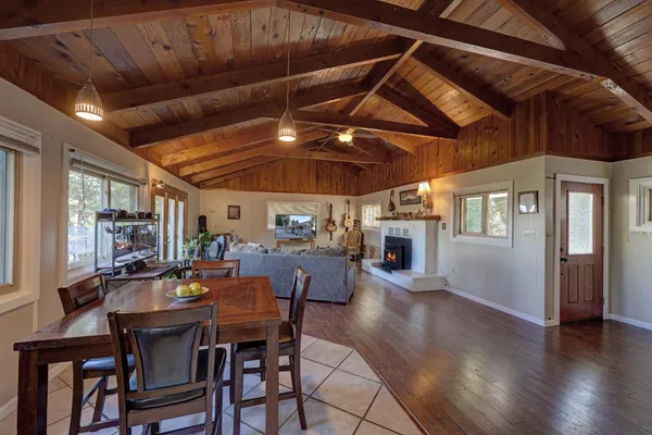 a dining room with wooden furniture and wooden floor