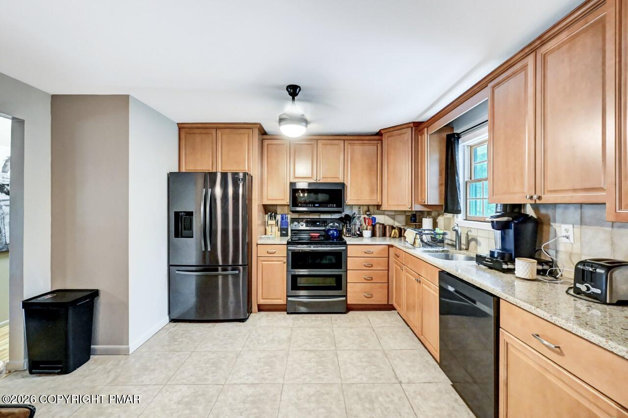 256 Devils Hole Road Cresco, PA 18326 - Photo 21 of 56 a kitchen with a refrigerator and a stove top oven