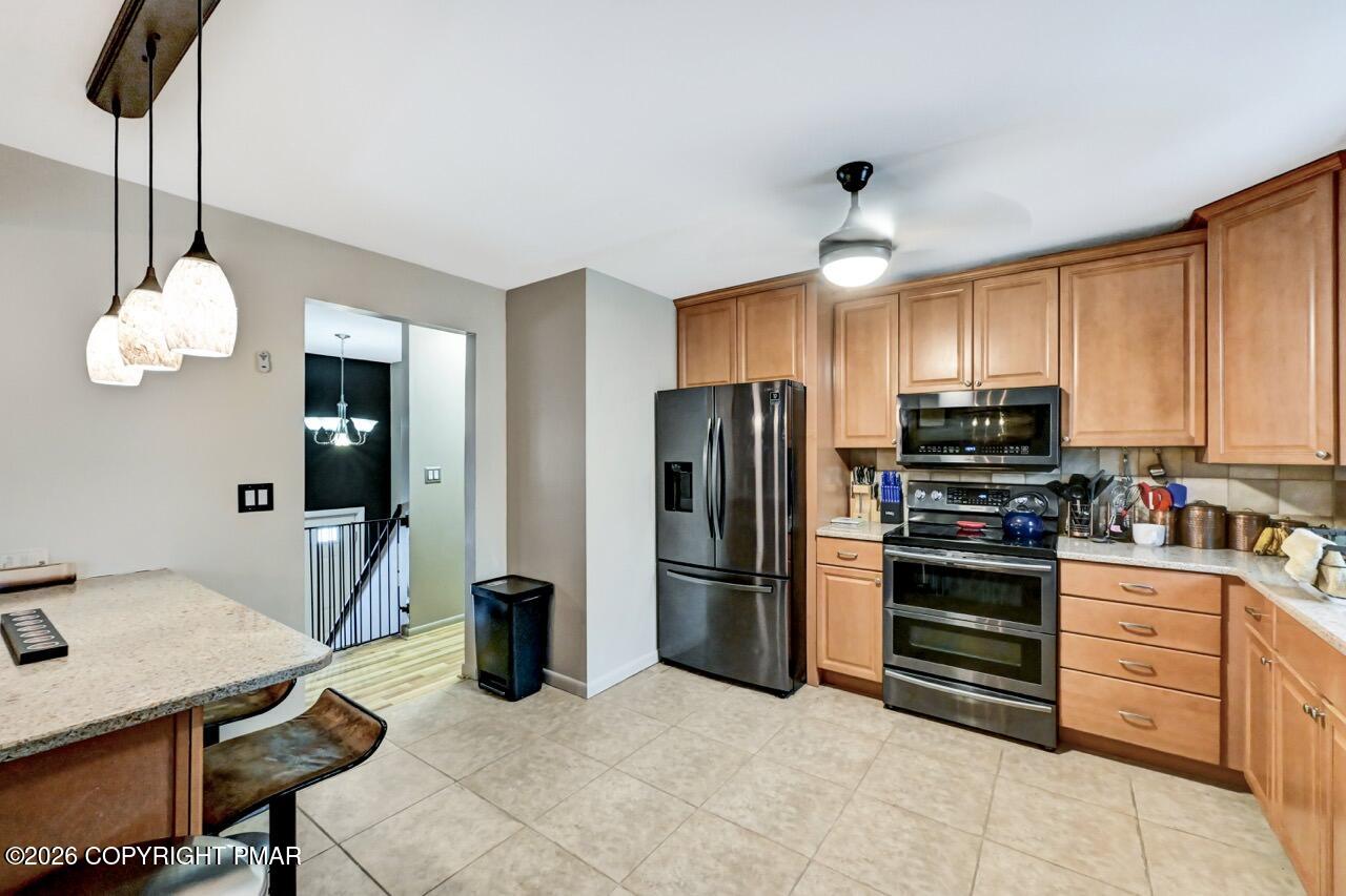 256 Devils Hole Road Cresco, PA 18326 - Photo 22 of 56 a kitchen with stainless steel appliances granite countertop a refrigerator oven a sink dishwasher and a stove with refrigerator