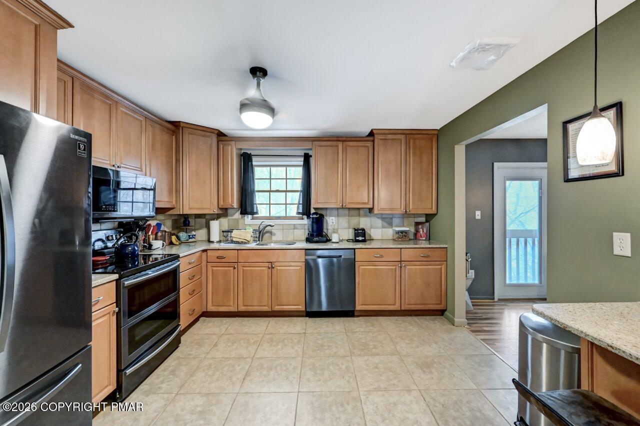 256 Devils Hole Road Cresco, PA 18326 - Photo 26 of 56 a kitchen with a stove top oven sink and cabinets