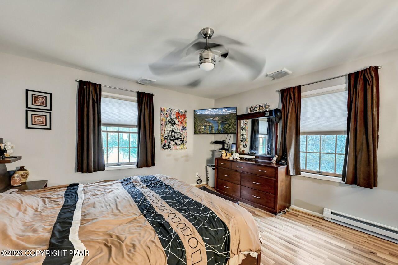 256 Devils Hole Road Cresco, PA 18326 - Photo 28 of 56 a bedroom with a large bed and a large window