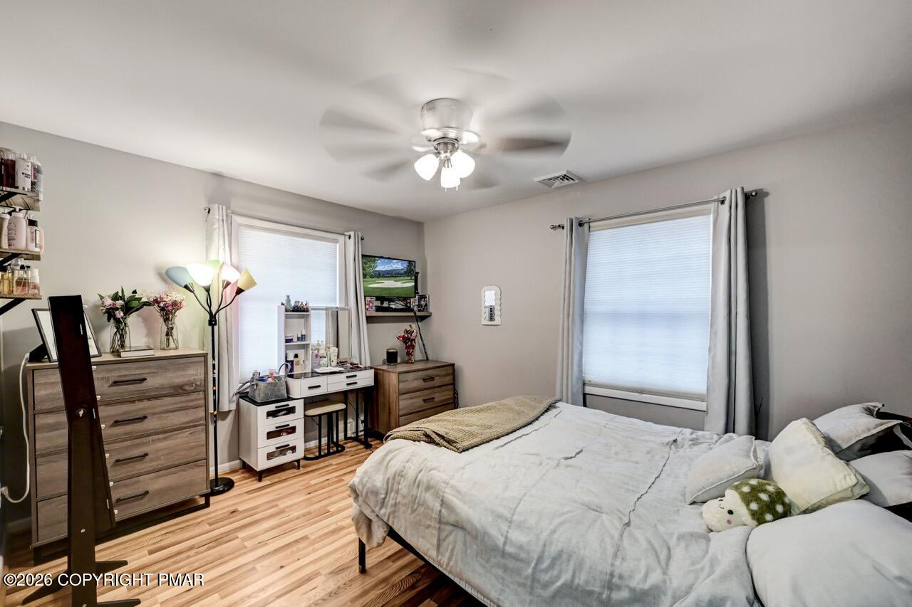 256 Devils Hole Road Cresco, PA 18326 - Photo 40 of 56 a bedroom with a bed and a chandelier