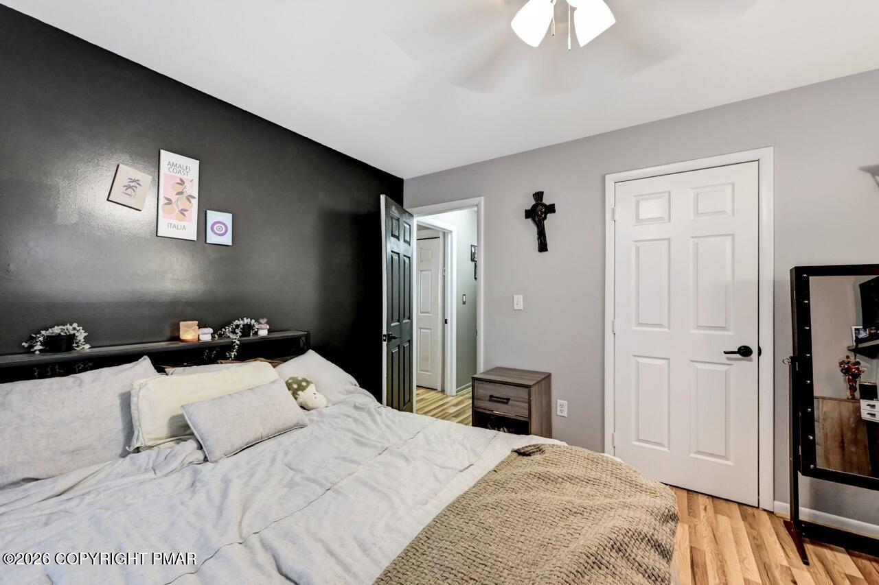 256 Devils Hole Road Cresco, PA 18326 - Photo 42 of 56 a bedroom with a bed and a chandelier