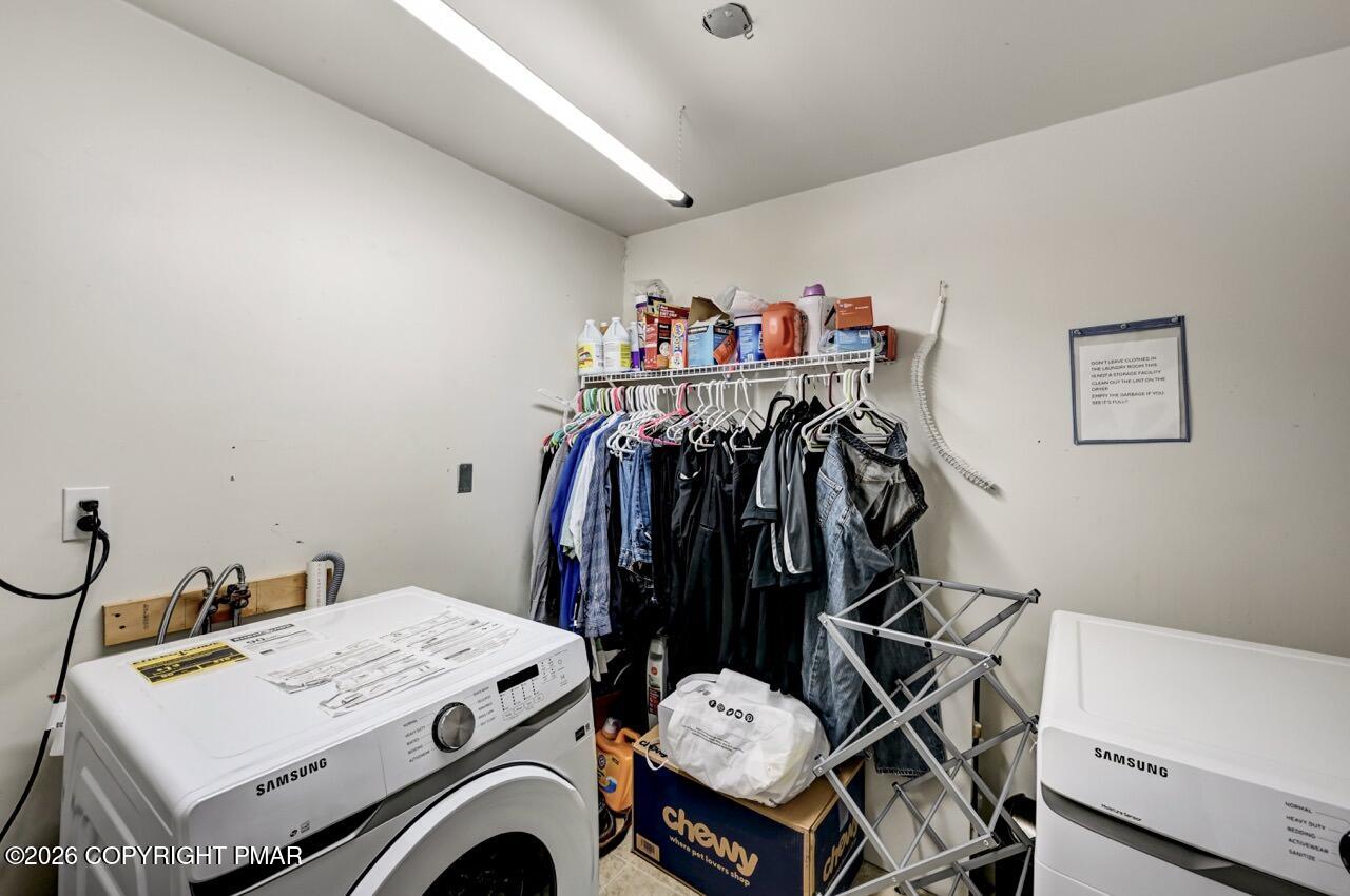 256 Devils Hole Road Cresco, PA 18326 - Photo 47 of 56 a utility room with dryer washer and a wooden floor