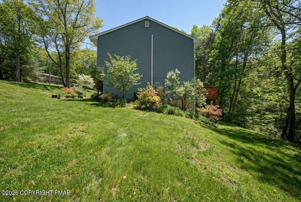 256 Devils Hole Road Cresco, PA 18326 - Photo 56 of 56 a backyard of a house with plants and large tree