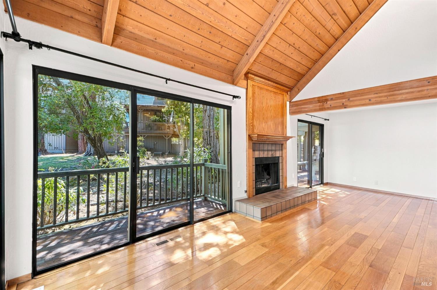 6485 Timber Springs Drive Santa Rosa, CA 95409 - Photo 10 of 67 Living room with gas starter fireplace and slider to wrap around deck, vaulted ceilings
