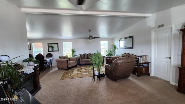 a utility room with dryer washer and a view of living room