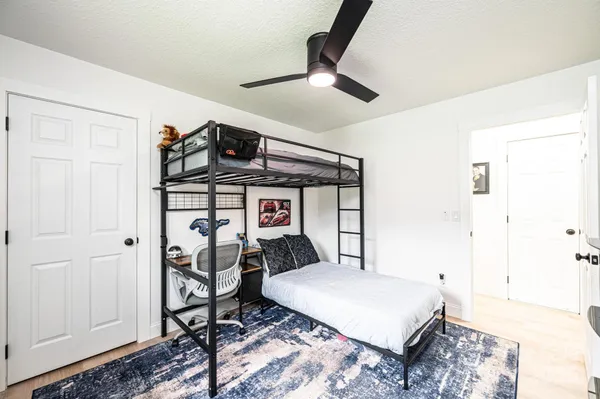a bedroom with a bed and a chandelier