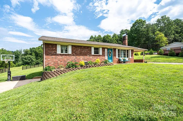 a front view of house with yard and green space