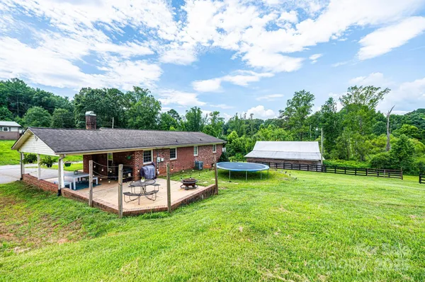 a view of a patio with table and chairs under an umbrella