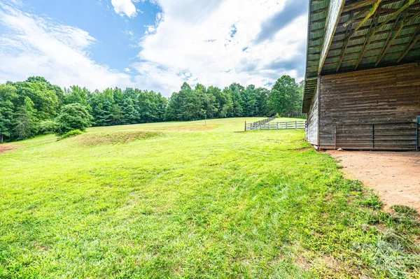 a view of a room with wooden floor and windows