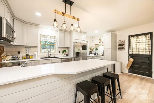 a large kitchen with granite countertop lots of counter space and window