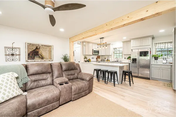a living room with furniture kitchen and a table