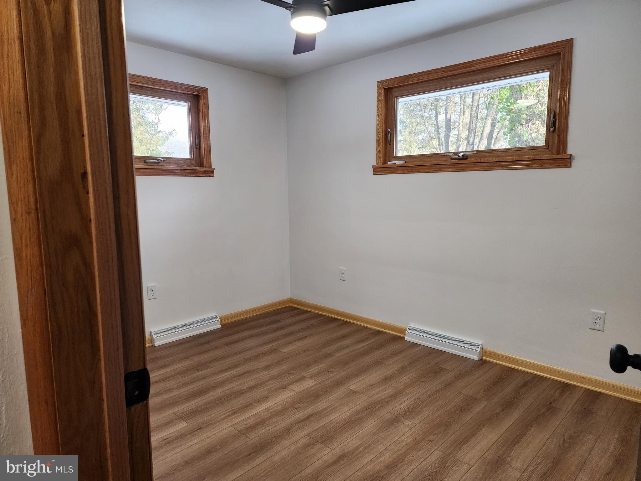 111 South Georgia Street Ridgeley, WV 26753 - Photo 40 of 79 an empty room with wooden floor chandelier fan and windows