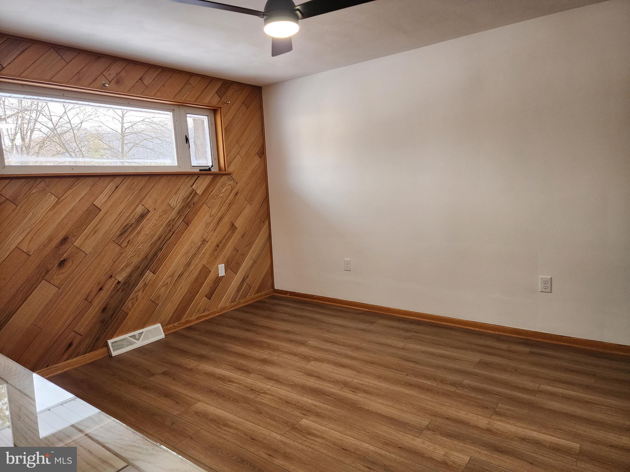 111 South Georgia Street Ridgeley, WV 26753 - Photo 42 of 79 a view of an empty room with wooden floor and a window