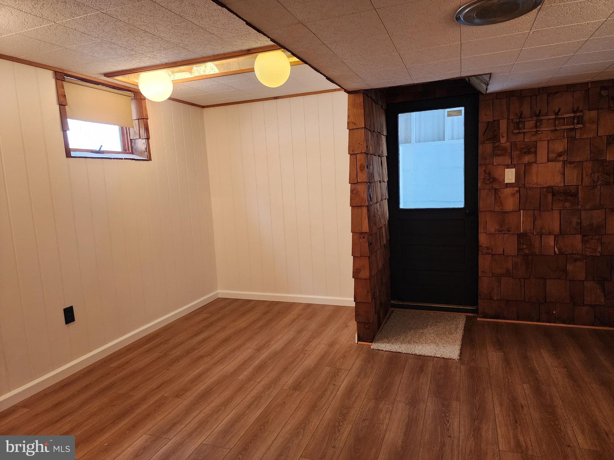111 South Georgia Street Ridgeley, WV 26753 - Photo 45 of 79 a view of an empty room with wooden floor and a window