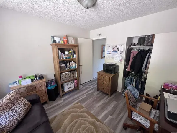 a bedroom with furniture and a book shelf