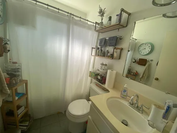 a bathroom with a sink mirror vanity and toilet