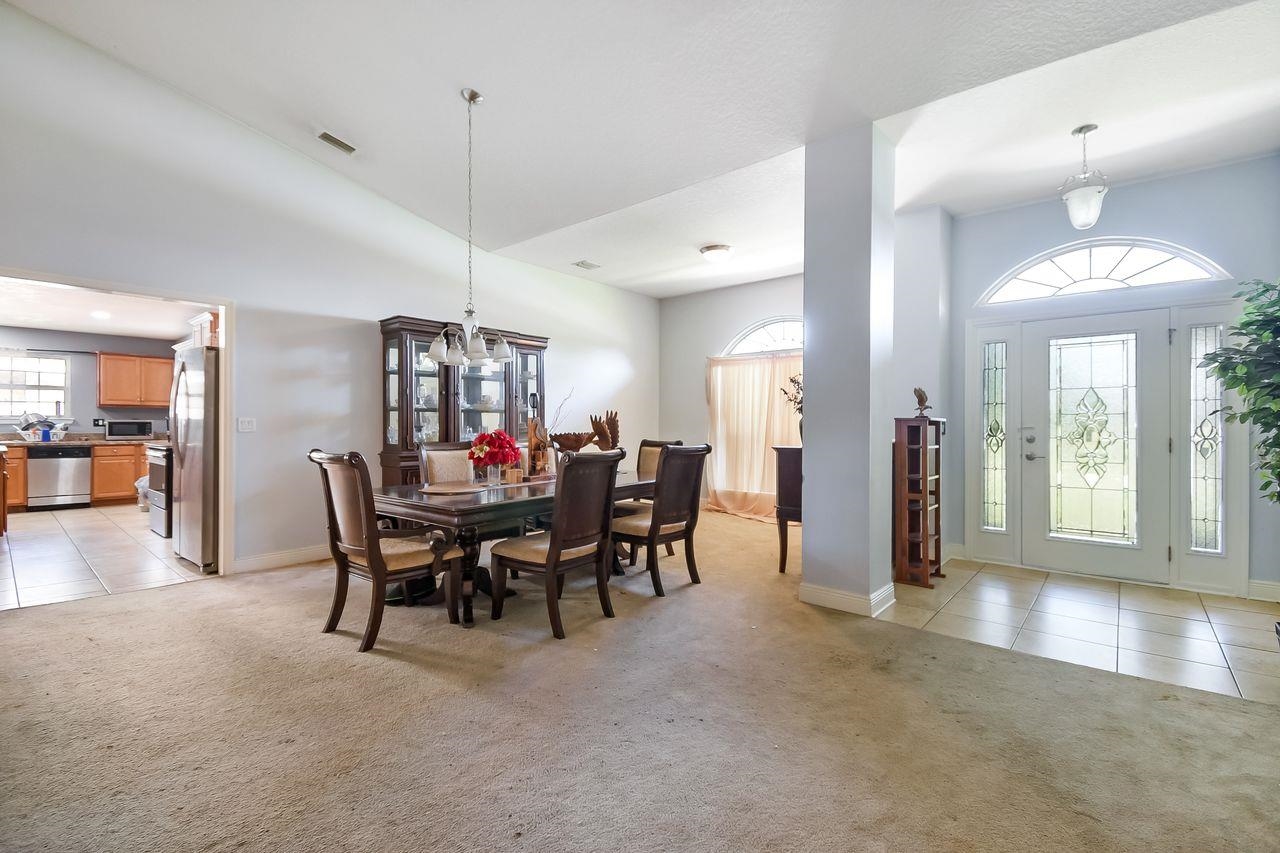 46 Riddle Drive Palm Coast, FL 32164 - Photo 9 of 20 a view of a dining room with furniture and a chandelier