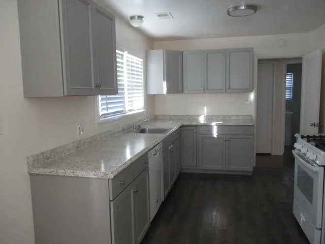 a kitchen with a sink stove and cabinets